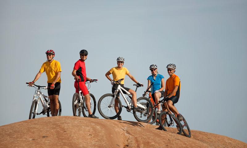 A group of friends resting along the Slickrock Trail in Moab